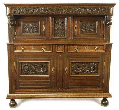 Appraisal: A Welsh oak press cupboard the moulded cornice above a