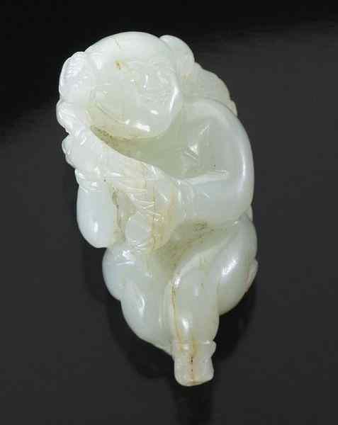 Appraisal: Chinese Ming carved white jade boyholding a lotus on a