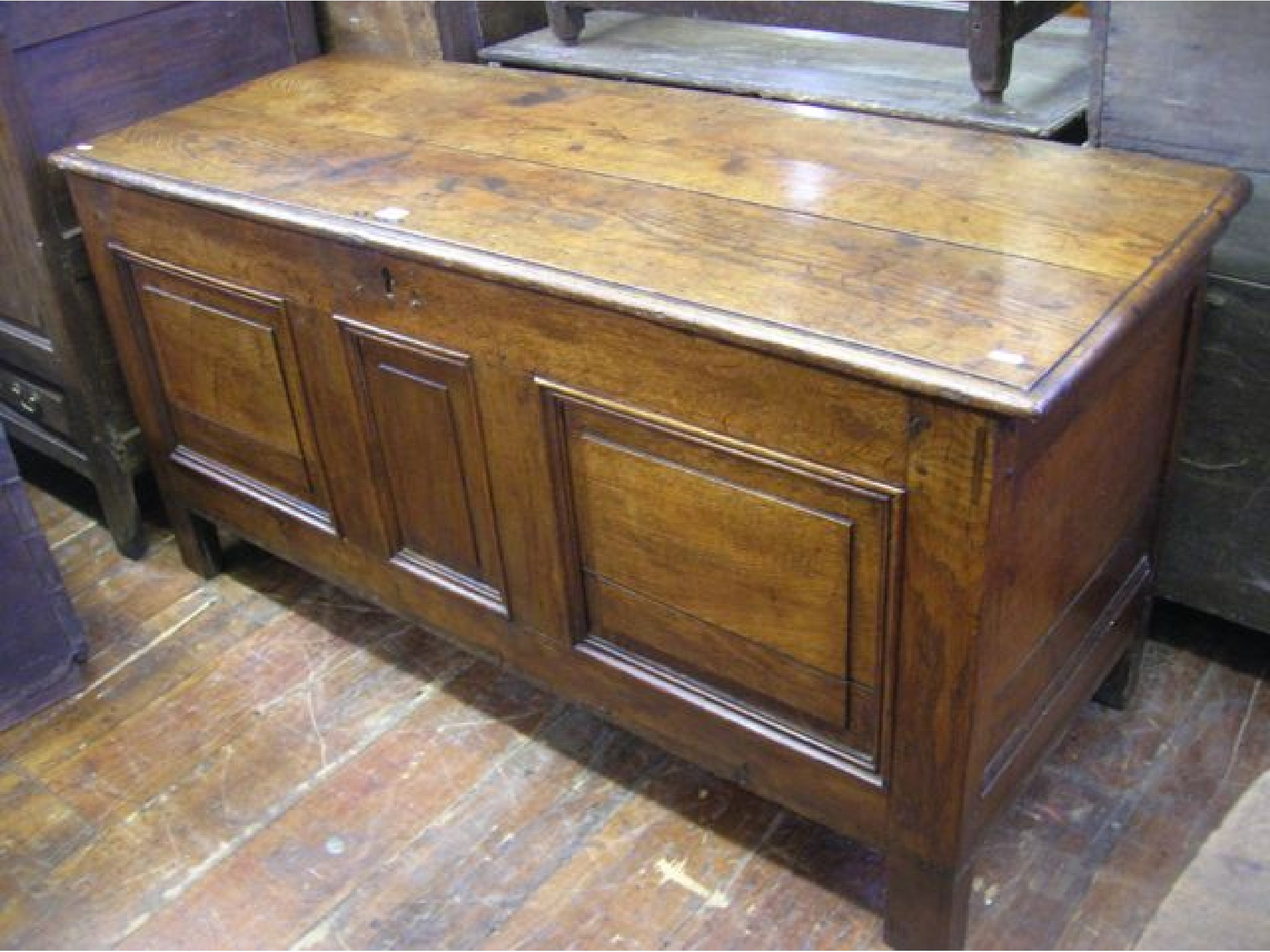 Appraisal: An th century oak coffer with plank top the pegged