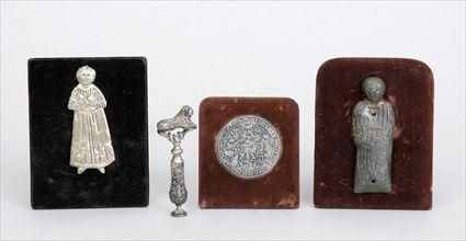 Appraisal: GROUP OF SMALL METAL DECORATIONS INCLUDING A SEAL Provenance From