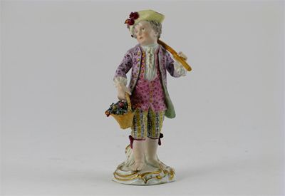 Appraisal: A Meissen figure of a boy carrying a basket of