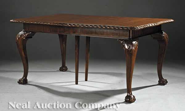 Appraisal: A George III-Style Carved Mahogany Dining Table rectangular top opening