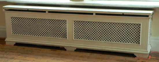 Appraisal: A double pierced cast radiator surround with white painted top