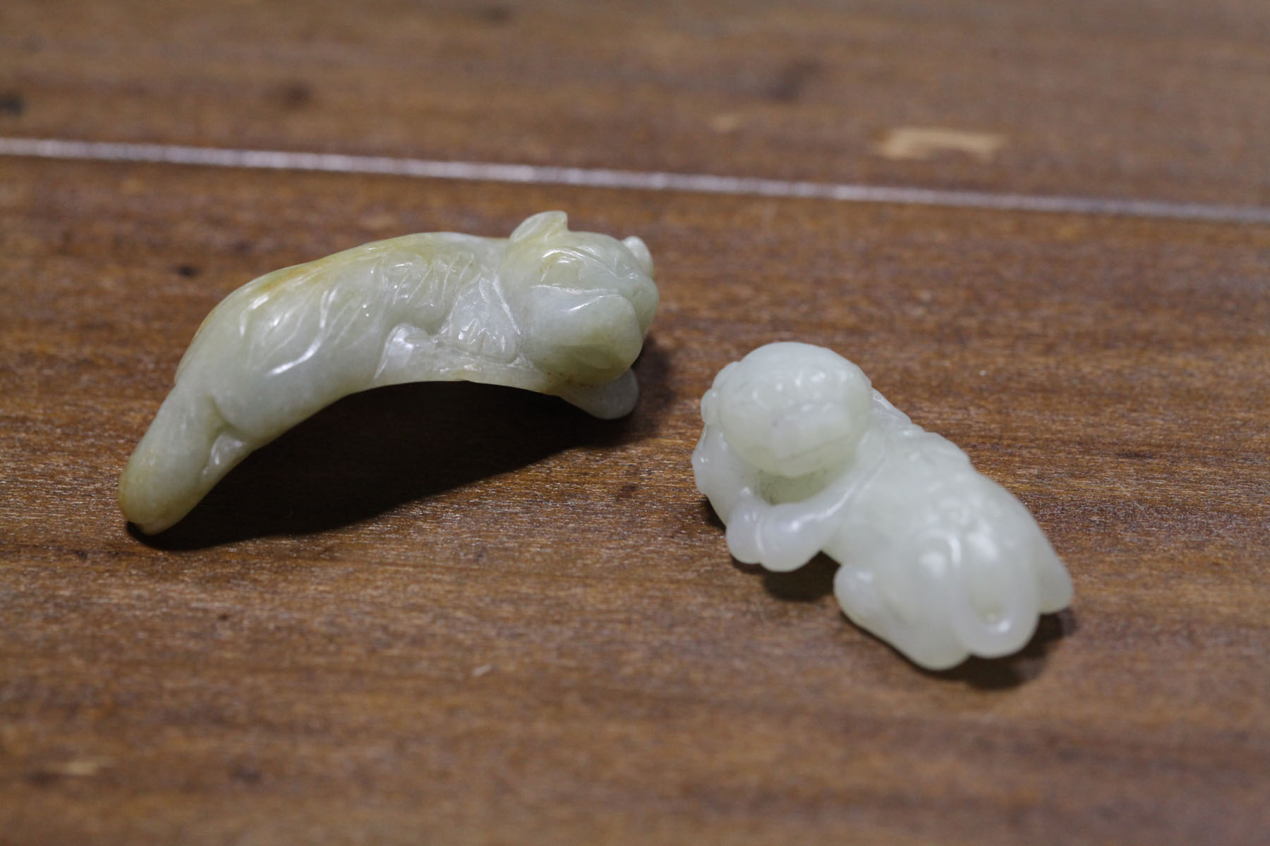 Appraisal: TWO CARVED STONES Asian th century probably jade Panthers White