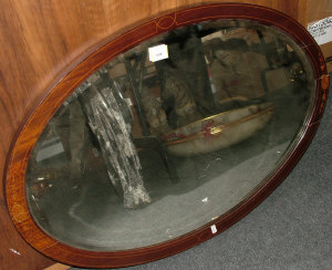 Appraisal: An Edwardian oval mahogany framed wall mirror with inlaid decoration