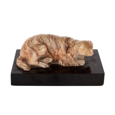 Appraisal: A carved alabaster figure of a recumbent dog th Century