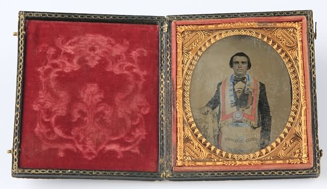 Appraisal: Sixth plate hand colored photograph on leather Pannotype of a