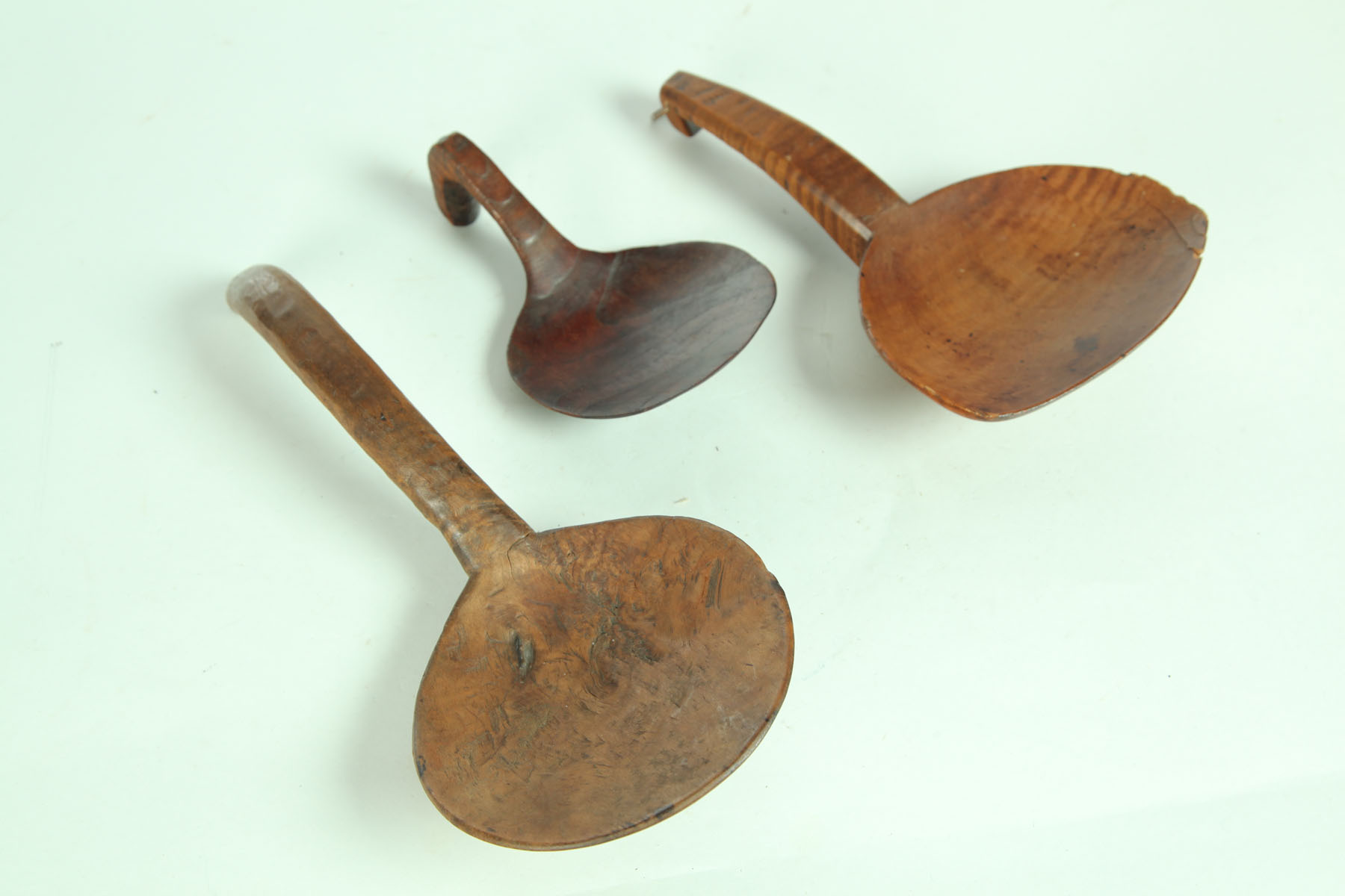 Appraisal: THREE BUTTER PADDLES American th century Curly maple with edge