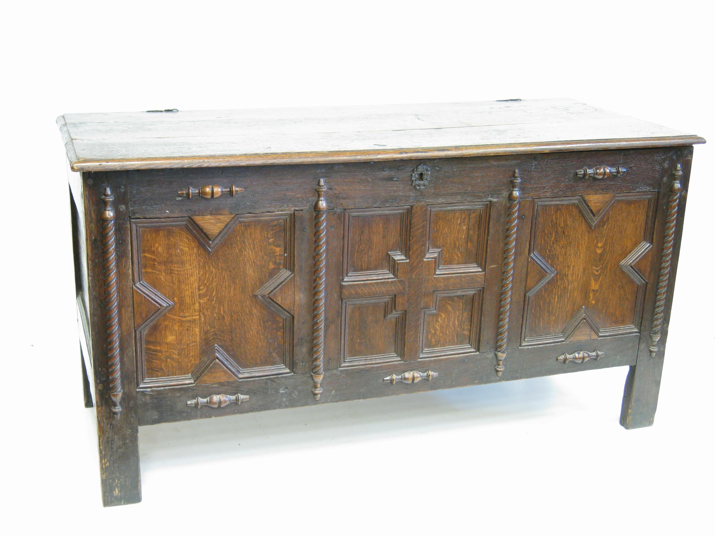 Appraisal: An antique oak Coffer with plank lid above three panel