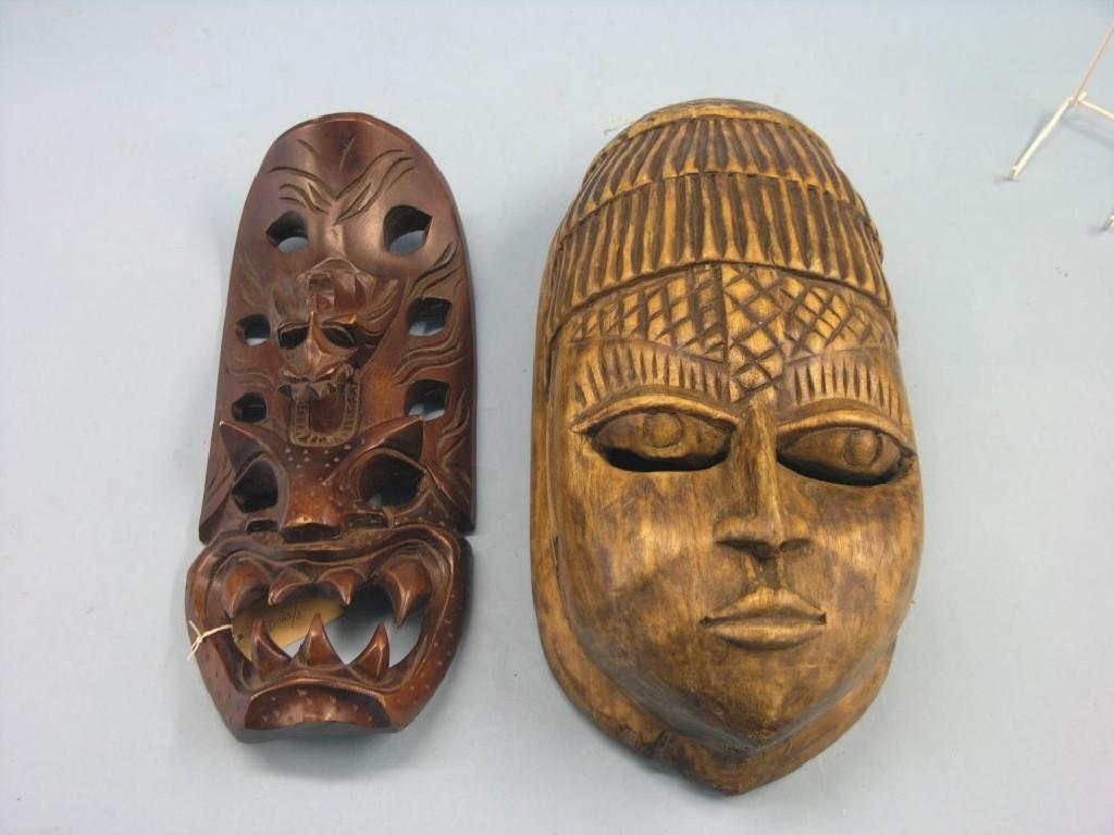 Appraisal: A pair of tribal carved wood masks in and in