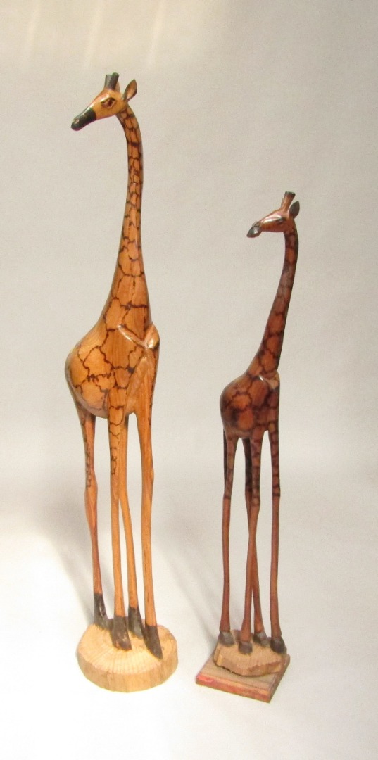 Appraisal: Two carved wooden figures of giraffes largest cm high