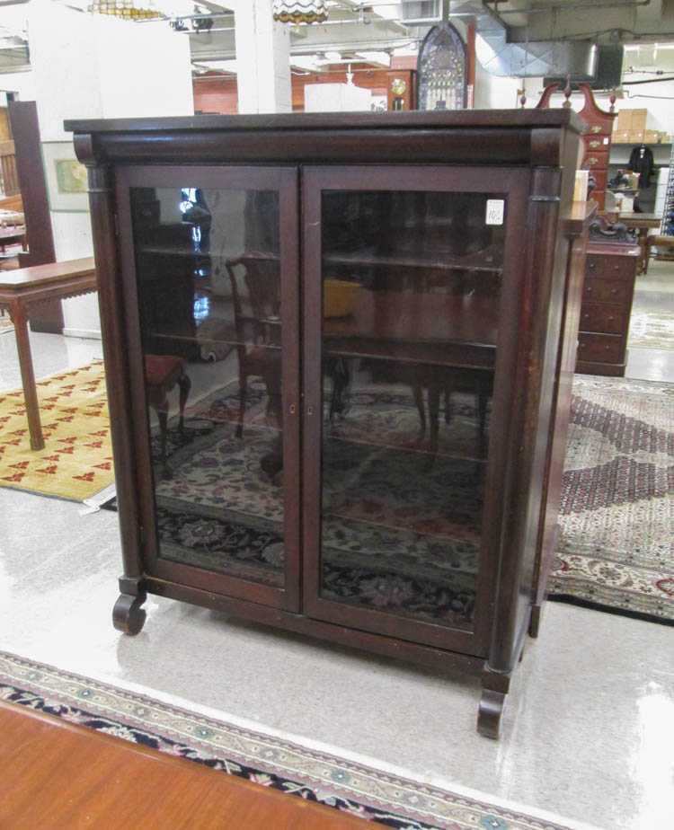 Appraisal: A MAHOGANY CABINET BOOKCASE Empire Revival style American c the