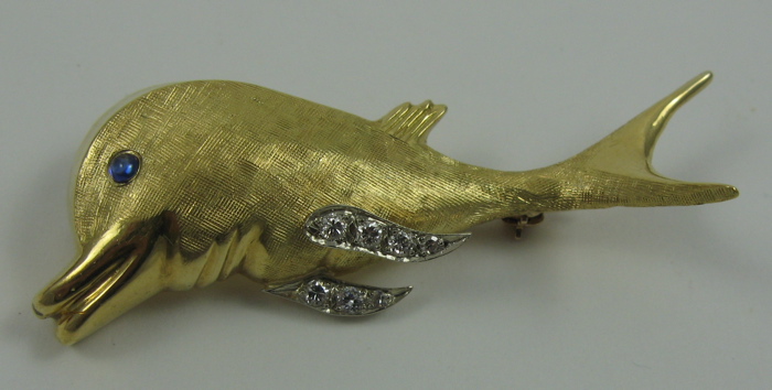 Appraisal: SAPPHIRE DIAMOND AND EIGHTEEN KARAT GOLD BROOCH The dolphin brooch