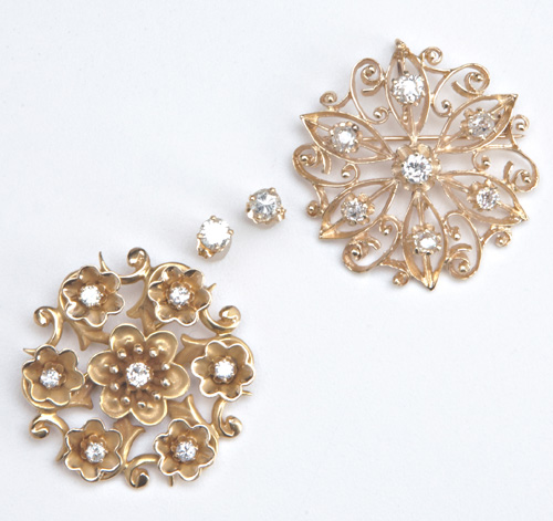 Appraisal: Two circular diamond brooches in k yg with a pair