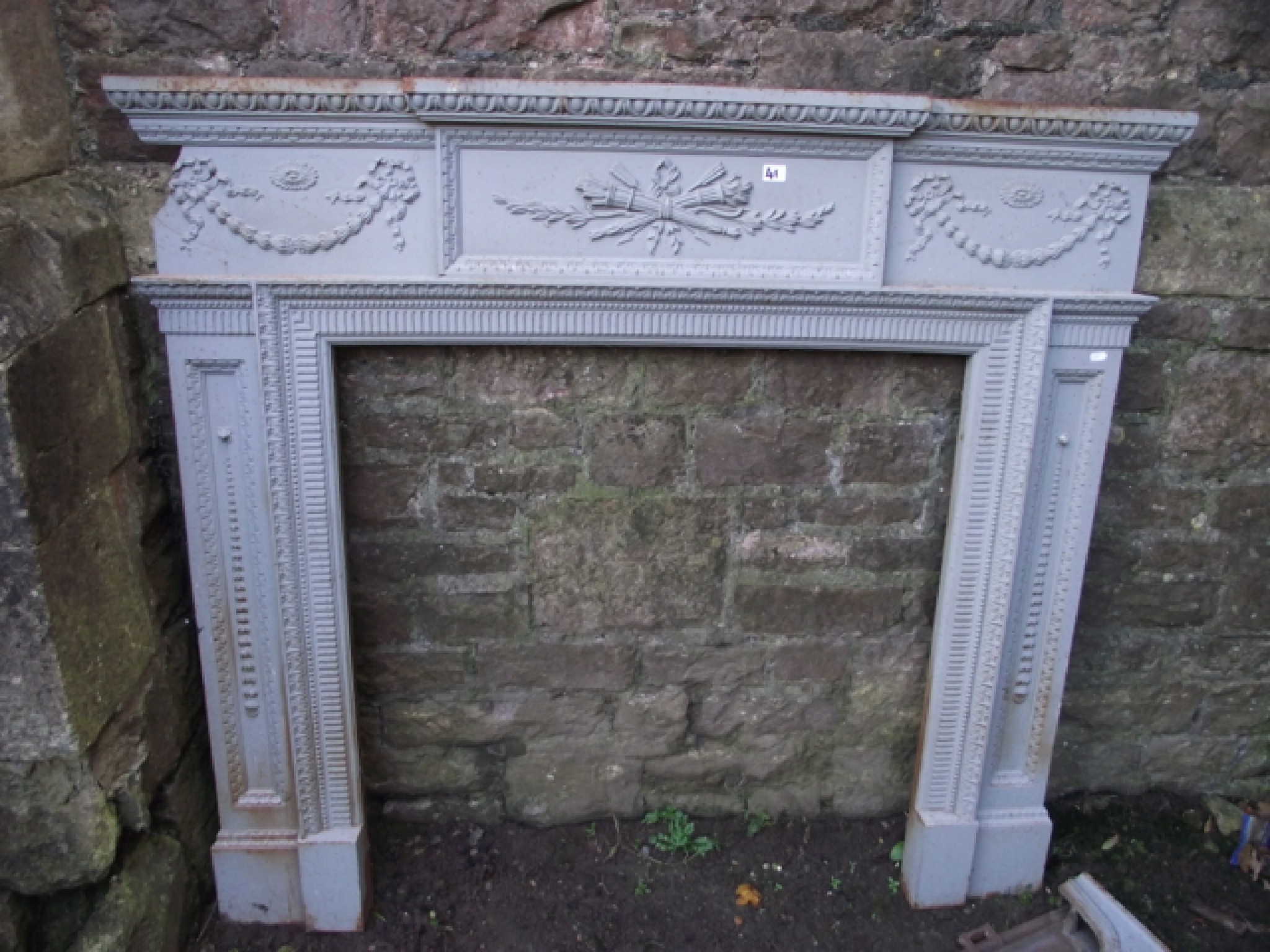 Appraisal: A reclaimed th century cast iron fire surround chimney piece