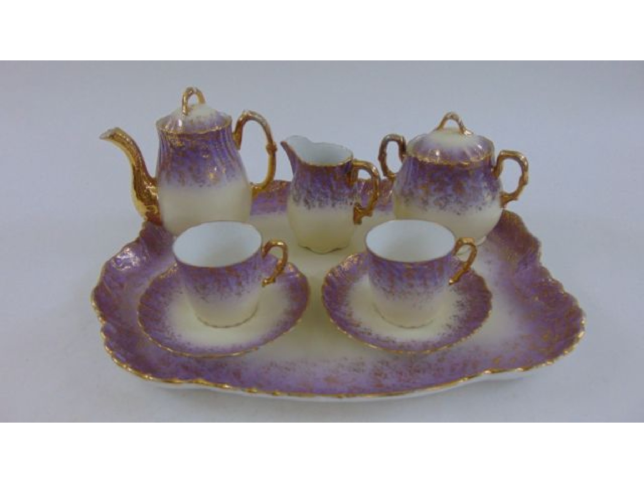 Appraisal: An early th century Limoges cabaret set with lilac and