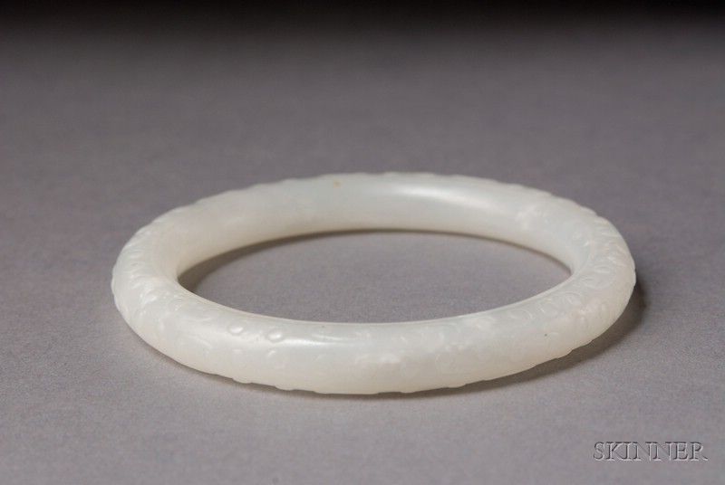 Appraisal: White Jade Bracelet China th century surface carved with archaic