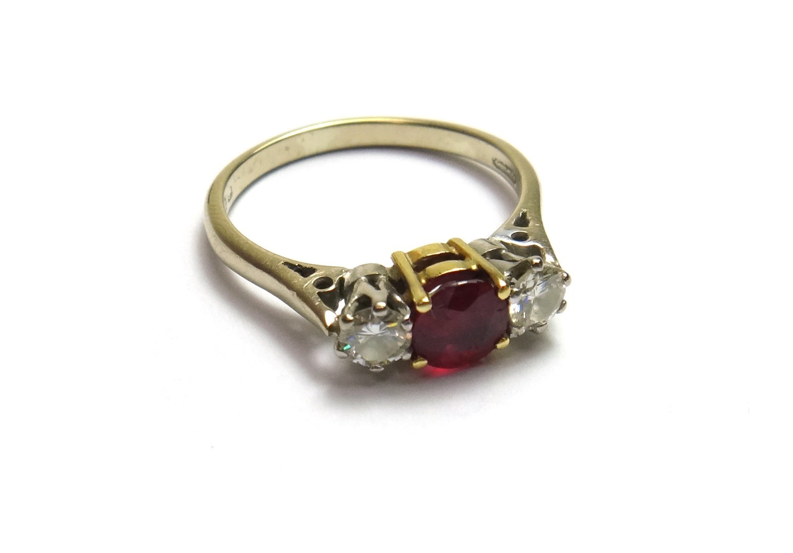 Appraisal: An ct white gold ruby and diamond set three stone