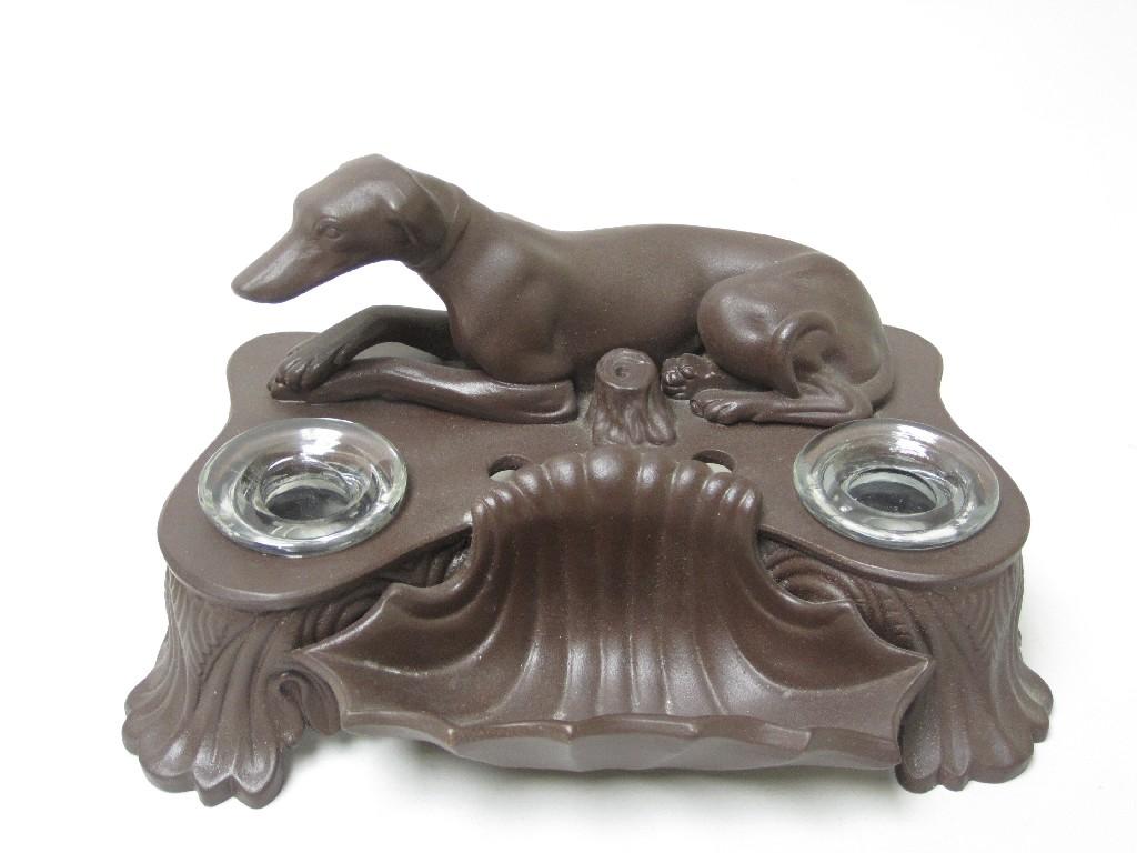 Appraisal: A Continental pottery Inkstand with greyhound surmount in