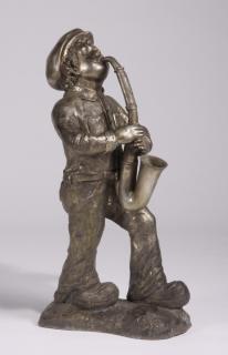 Appraisal: Bronze sculpture boy playing saxophone h Contemporary silver over bronze