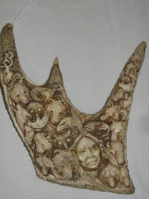 Appraisal: A CARVED MOOSE HORN depicting a Red Indian mask and