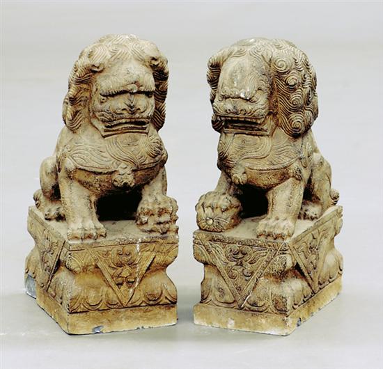 Appraisal: Pair carved stone foo lions mythological creature on architectural plinth