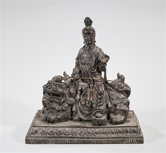 Appraisal: Chinese metal figure of Guanyin riding a fo lion x