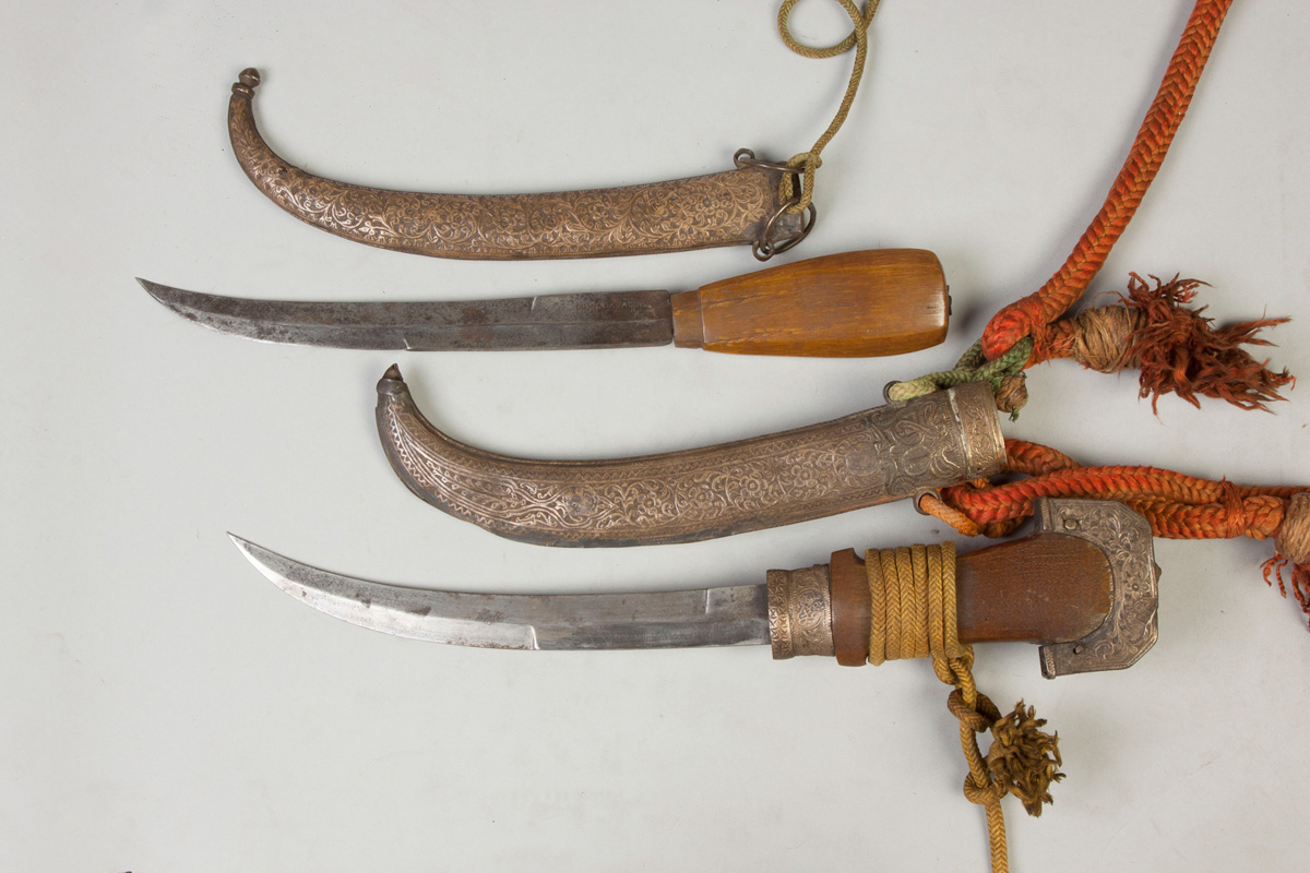 Appraisal: Two Middle Eastern Knives Hand chased mounts horn handles Both