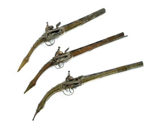 Appraisal: THREE MIQUELET FLINTLOCK PISTOLS Middle Eastern th century Brass mounted