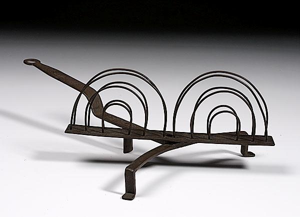 Appraisal: DECORATED WROUGHT IRON TOASTER American th century with rotating rack