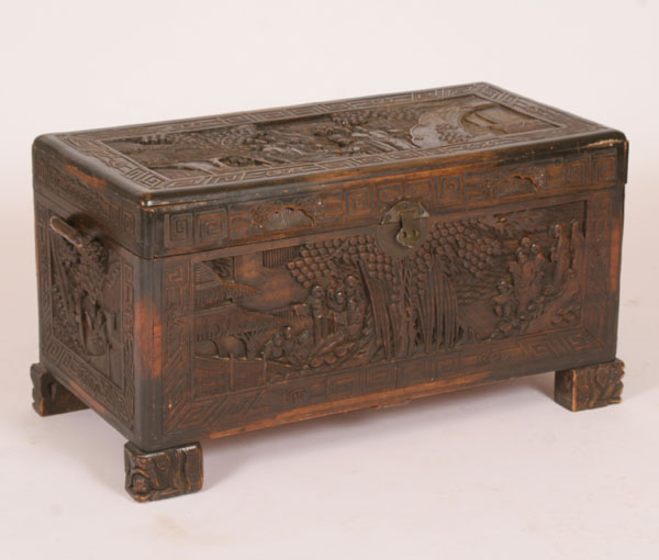 Appraisal: Chinese carved footed camphor chest deep scenic carving on all