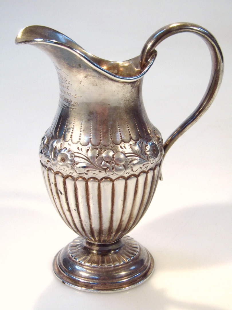 Appraisal: A Victorian silver cream jug the helmet shaped body with