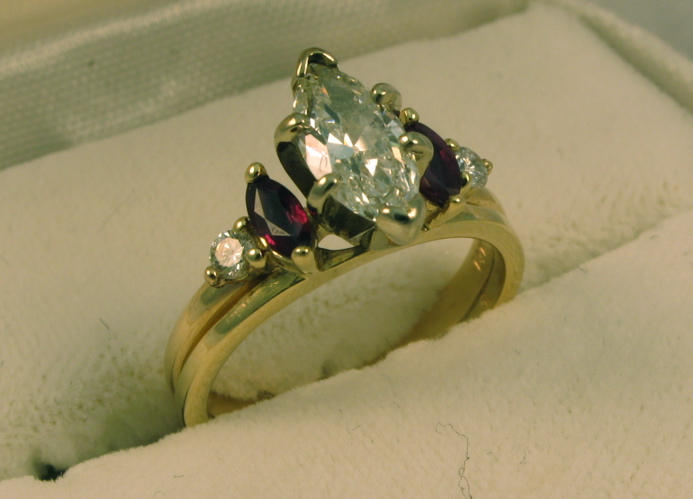 Appraisal: DIAMOND GARNET AND FOURTEEN KARAT GOLD RING centering a marquise-cut