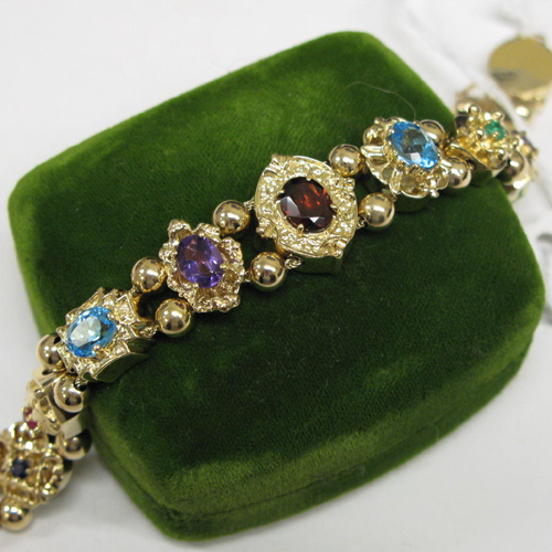 Appraisal: COLOR GEMSTONE AND TEN KARAT GOLD BRACELET set with emeralds