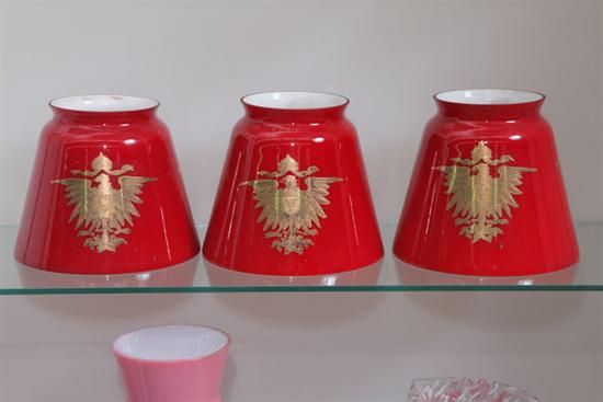 Appraisal: THREE LAMP SHADES Milk glass cased in red with a