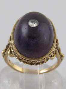 Appraisal: A carat gold cabochon amethyst ring with diamond set centre