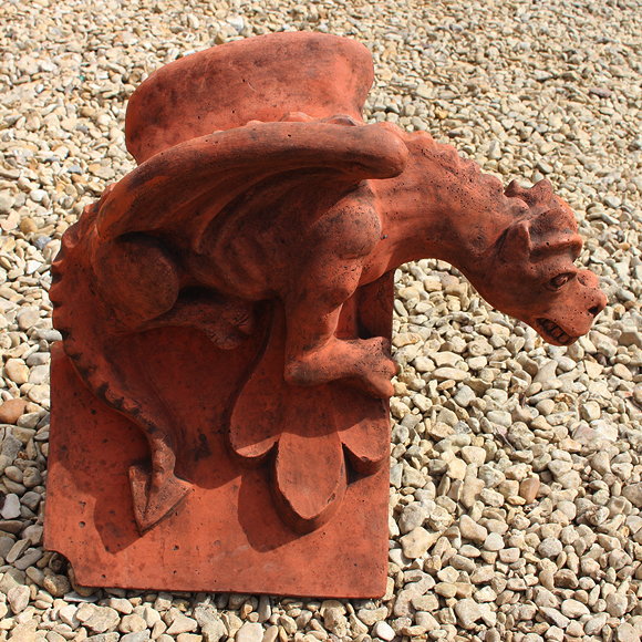 Appraisal: A CAST TERRACOTTA COLOURED DRAGON ROOF RIDGE FINIAL a dragon