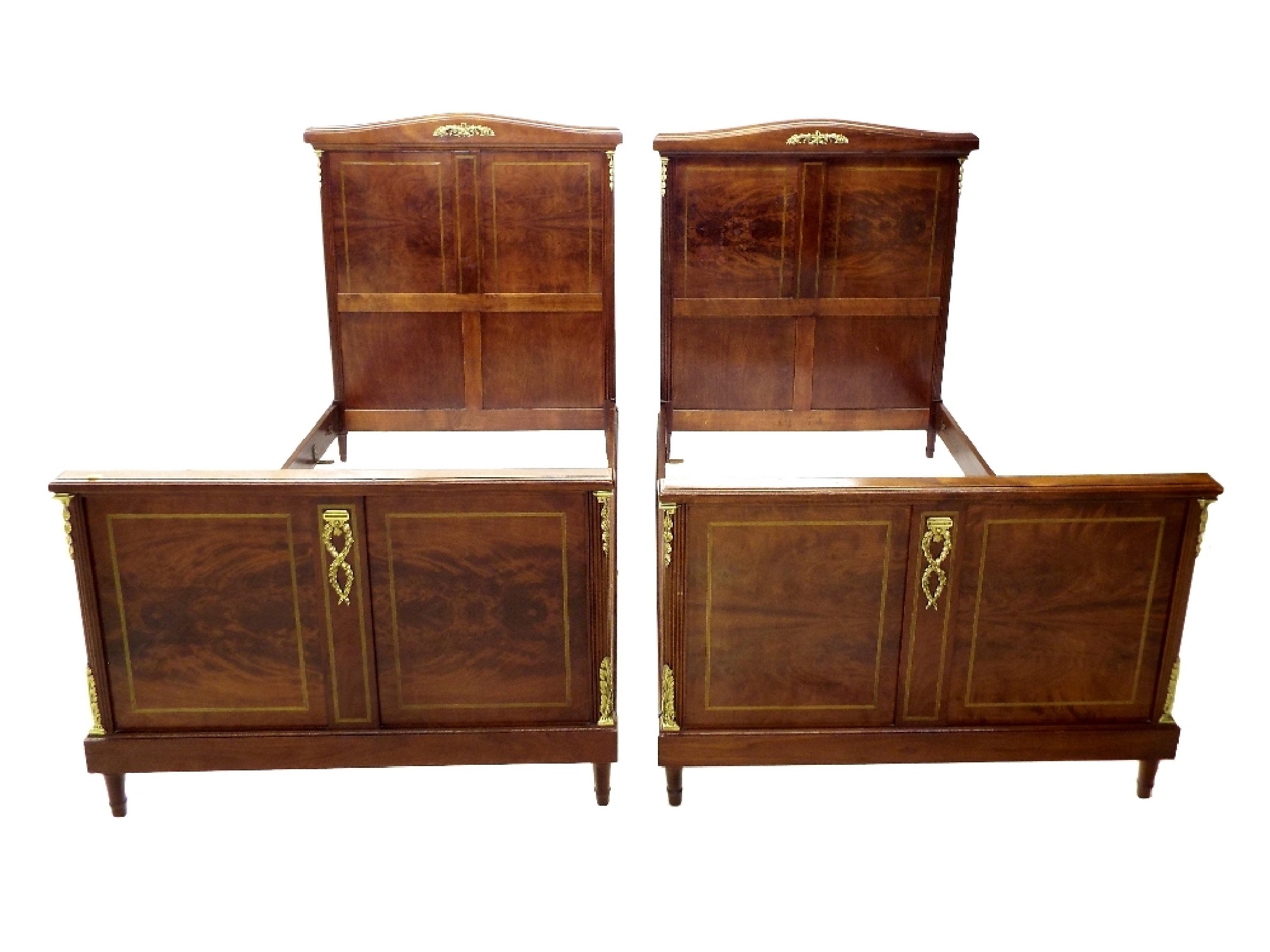 Appraisal: Pair of French Empire style flame mahogany single bed frames