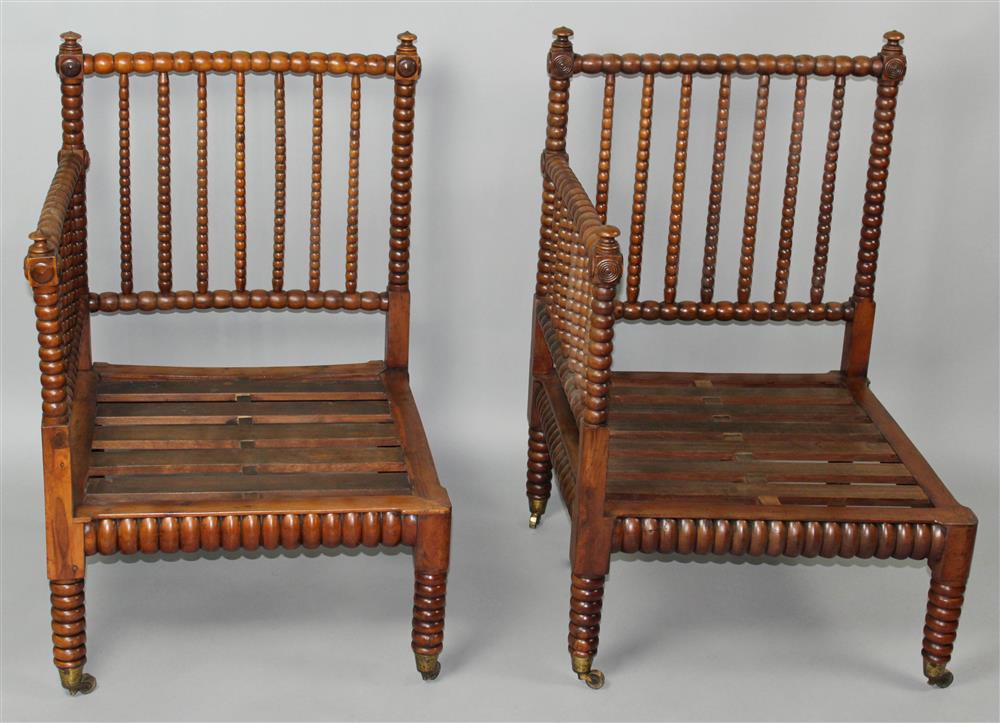 Appraisal: TWO SIMILAR HUNTZINGER STYLE SPOOL TURNED CORNER CHAIRS each having