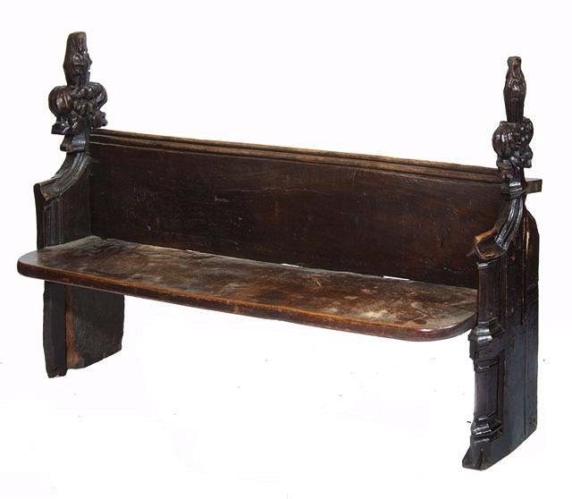 Appraisal: AN EARLY ENGLISH CARVED OAK PEW with stylised foliate end