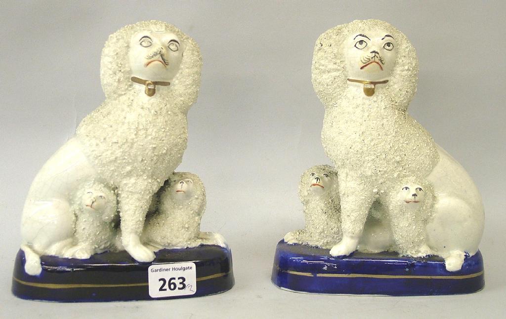 Appraisal: Pair of seated Staffordshire poodle groups with rough coats supported