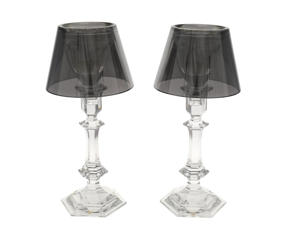 Appraisal: A pair of Baccarat Harcourt Our Fire candlesticks by Philippe