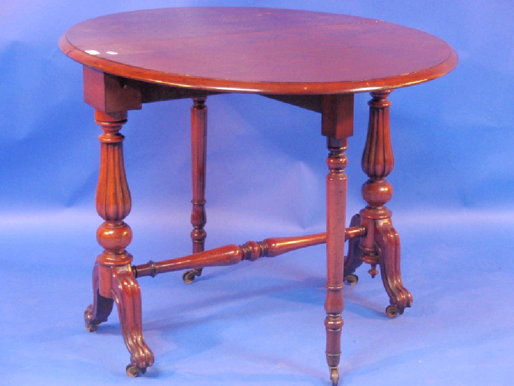 Appraisal: A Victorian walnut Sutherland table with moulded oval top and