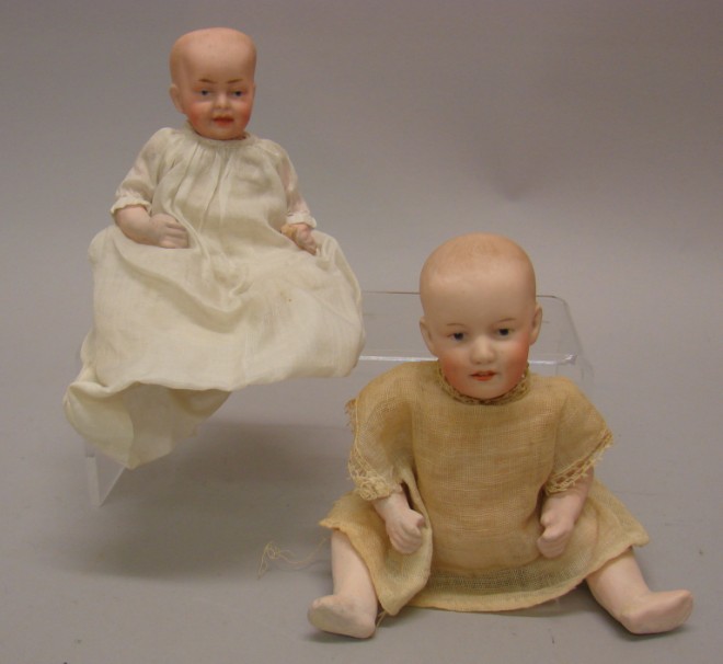 Appraisal: Pair of and Heubach solid dome babies Both have molded