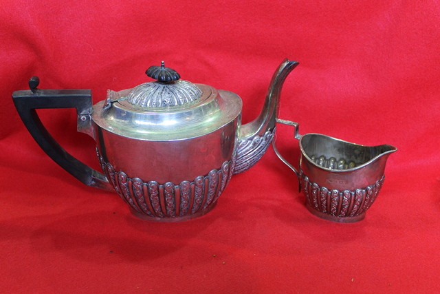 Appraisal: A SILVER TEAPOT and cream jug of baluster form with