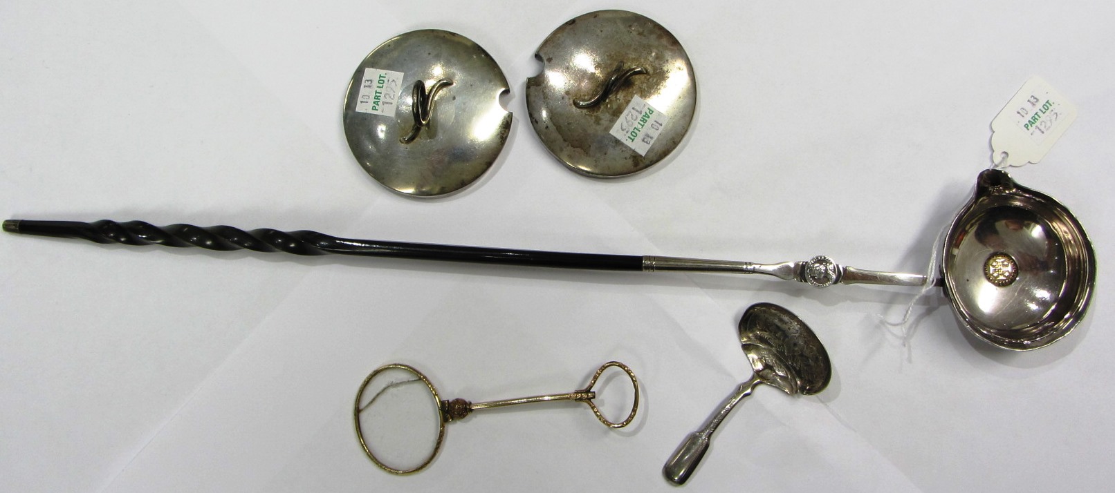 Appraisal: A silver toddy ladle the bowl fitted with a Portuguese