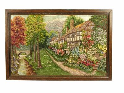 Appraisal: A woolwork picture depicting a row of thatched cottages and