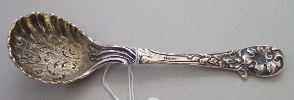 Appraisal: A Victorian silver and gilt sugar sifting spoon with floral