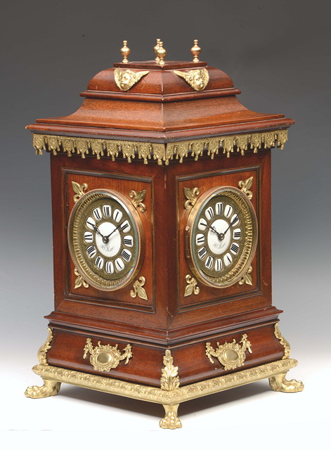 Appraisal: AN EARLY TH CENTURY MAHOGANY TABLE CENTRE TIMEPIECE each side