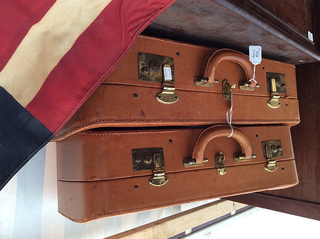 Appraisal: TWO GRADUATED TAN LEATHER SUITCASES the interior with labels for